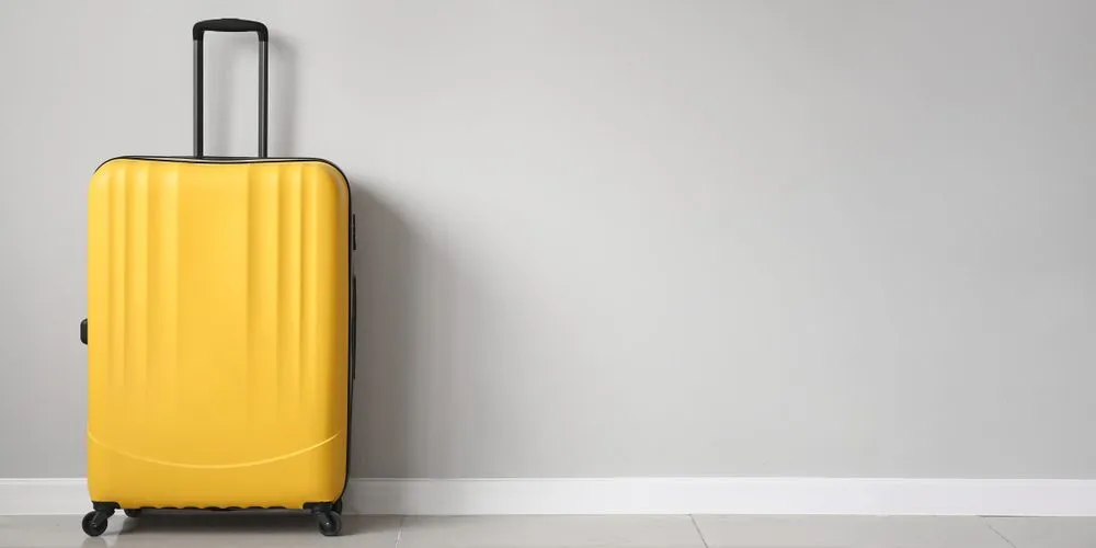 Packed,Suitcase,Near,Light,Wall
