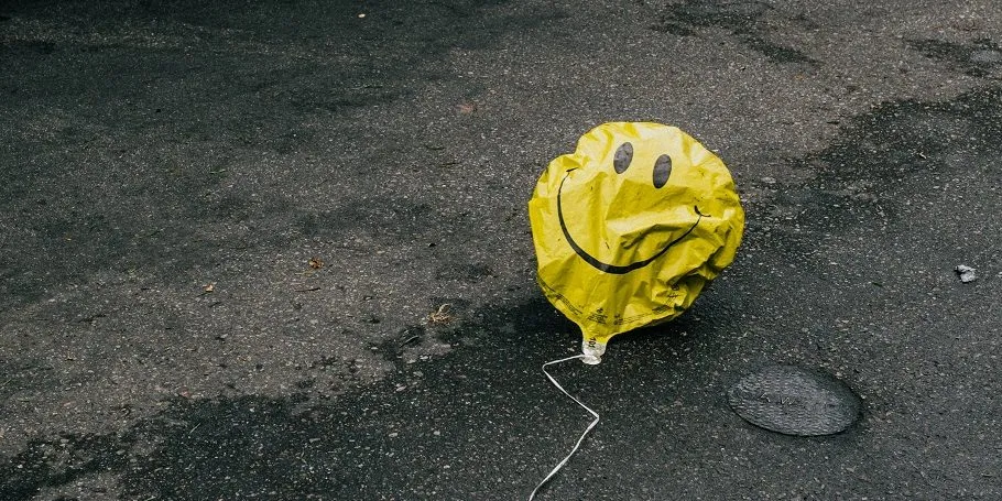 yellow balloon on road deflated