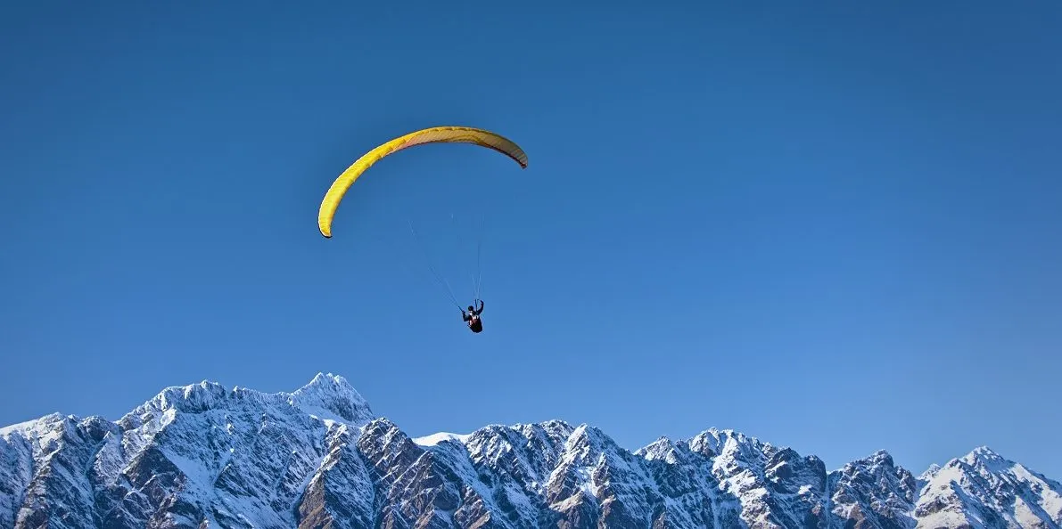 career change implied by someone parachuting over mountains